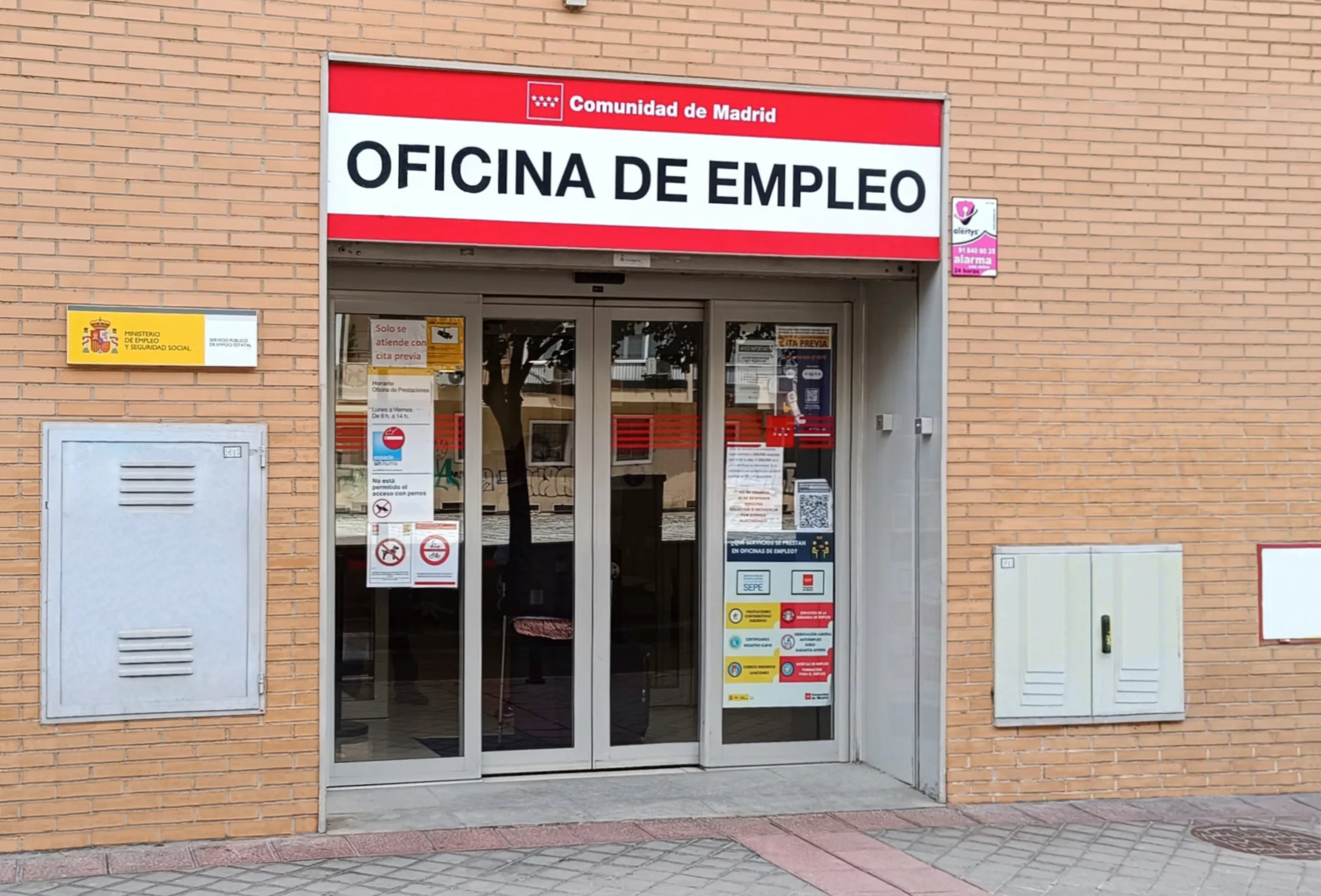Fachada de una Oficina de Empleo en el barrio de la Concepción (Madrid), con los logotipos del SEPE y de la Comunidad de Madrid sobre la entrada de cristal.