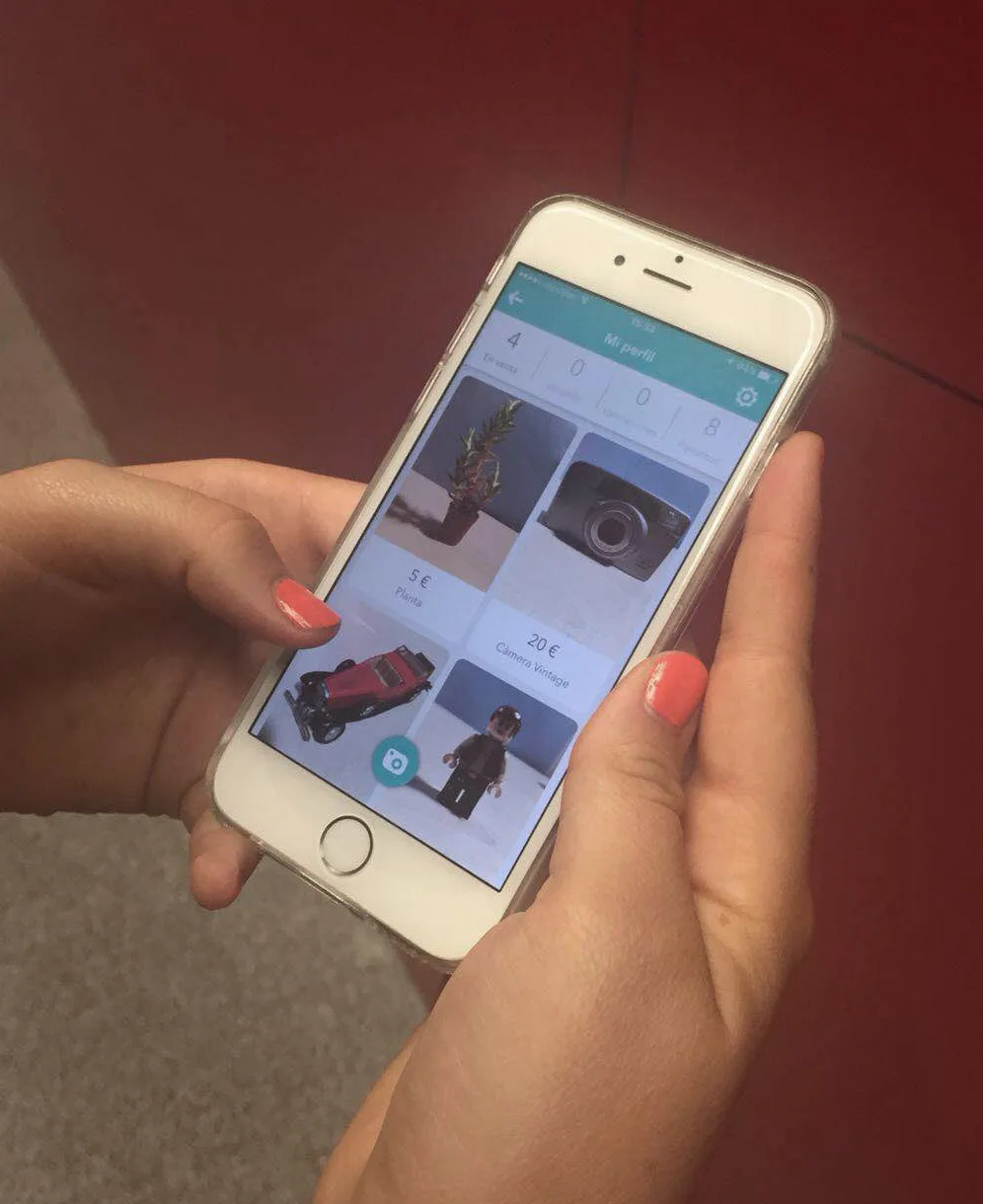 Usuaria utilizando la aplicación móvil de Wallapop en la pantalla de un smartphone.